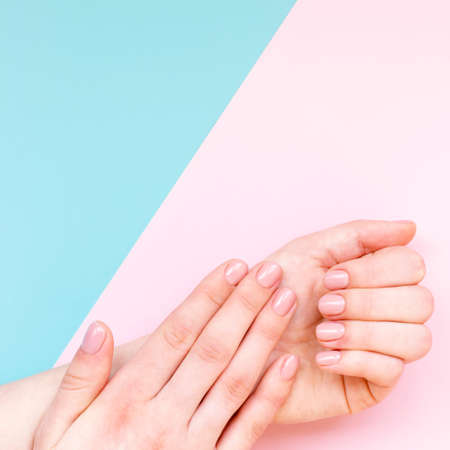 Women's manicure. Cosmetology and hand care. Beautiful, neat pink manicure.の写真素材