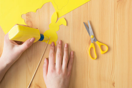 Easter bunny step by step instructions. Step 3 glue the wooden shelf to the rabbit.の写真素材