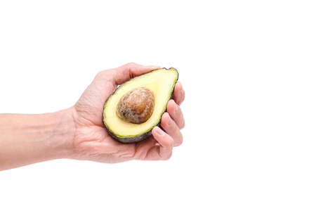 Avocado. Hand holds an avocado on a white background. Isolate.