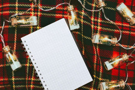 Christmas blank notepad with lights. New Year's wishlist.の写真素材