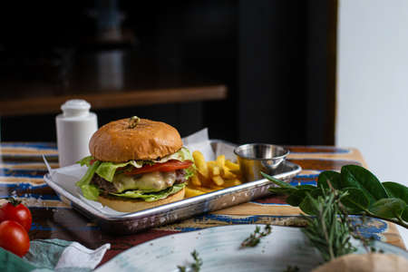 Hamburger with French fries on a dark backgroundの写真素材