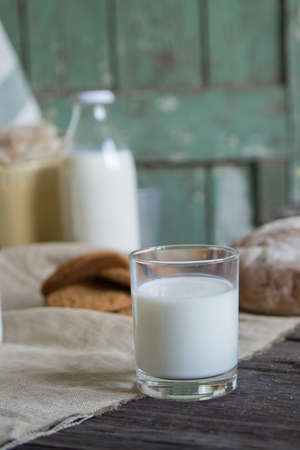 Milk, homemade bread and cookies. Farm products on a wooden table.の写真素材