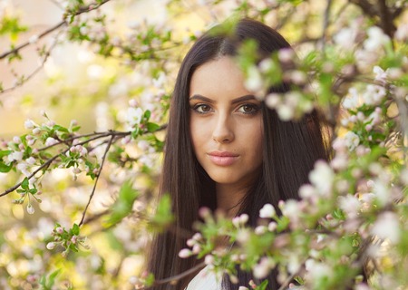 Portrait of a sensual young brunette female on field sexy short