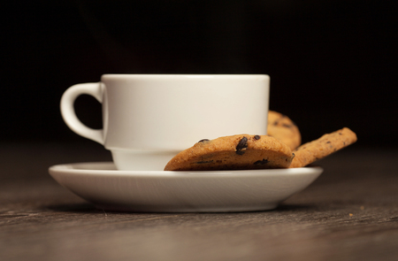Cup of tea on a wooden background top view. Chocolate chip cookies. Blurred background.の写真素材