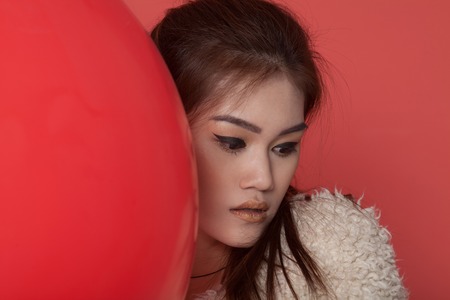 Young asian attractive sexy fashion model with long blond natural hair, beautiful eyes, full lips, perfect skin is posing in studio for glamour vogue test photo shootの写真素材