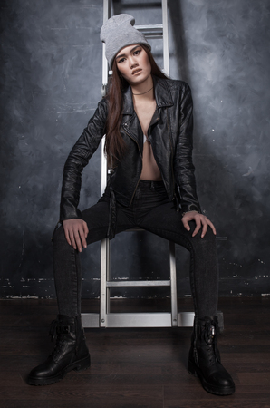 Fashion shot beautiful sexy girl in jeans and leather jacketの写真素材