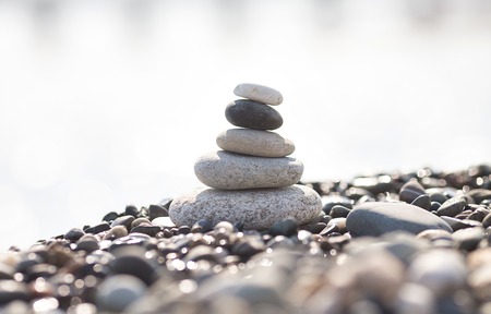 Pyramid of stones on the beach. Blurred background.の写真素材