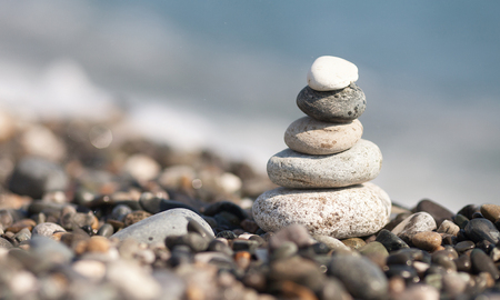 Pyramid of stones on the beach. Blurred background.の写真素材