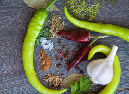 Different Vegetables and spices on wooden background close up. Onion,garlic,pepper.