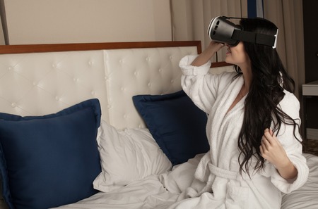 Woman in virtual reality helmet. VR glasses.