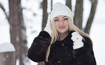 Laughing beautiful blond girl portrait in winter time with snow.の写真素材