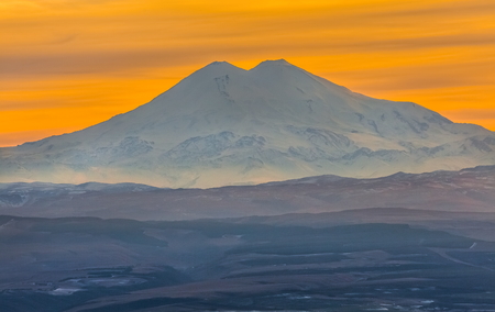 Mountains in the fog, haze. The Main Caucasian Range. Multicolored background. Mountains at sunset....