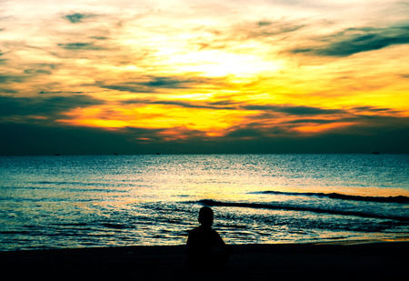 lonely boy on the beach Silhouette and effect toneの写真素材