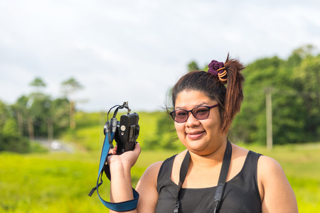 Young photographer taking pictures with film cameraの写真素材