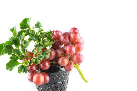 Ripe red grapes with glass isolateの写真素材