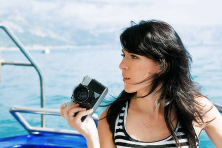 A young woman with a cameraの写真素材