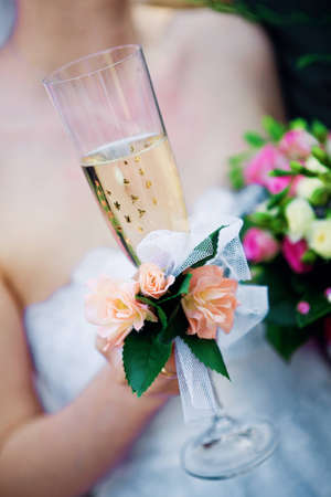 Bride with a glass and a bouquetの写真素材