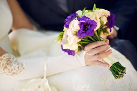 Bouquet in the hands of the bride and groomの写真素材