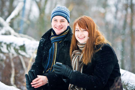 Young couple in love smiling in winterの写真素材