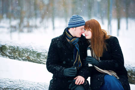 Young couple in love smiling in winterの写真素材