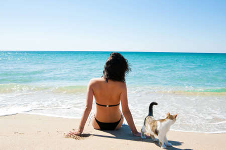 Girl on the beach with a kittenの写真素材
