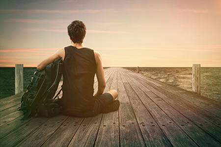 Man sitting on a Jettyの写真素材