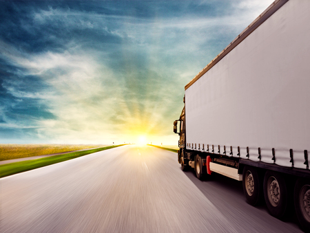 Truck driving towards sunsetの写真素材