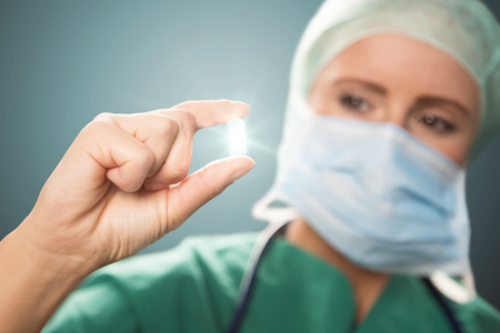 Doctor with a glowing pillの写真素材
