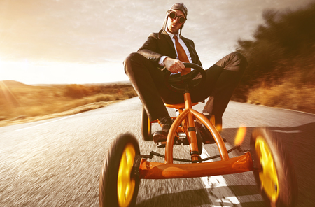 Confident Businessman on Pedal Carの写真素材