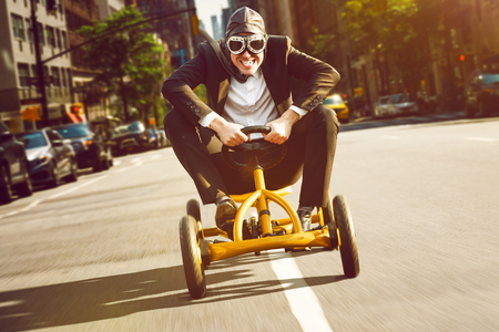 Businessman on a pedal car