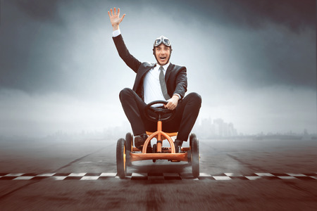 Happy Businessman on a pedal carの写真素材