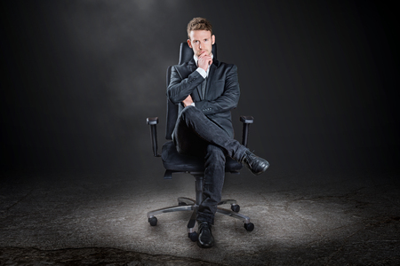 Boss posing on a chairの写真素材