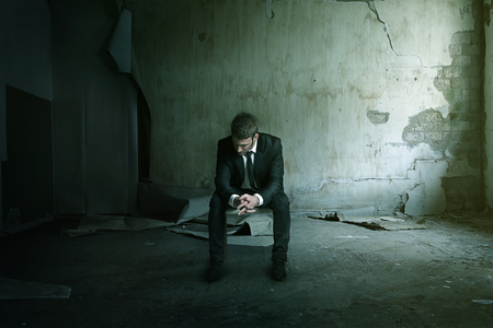 Smashup man sit on chair depressedの写真素材