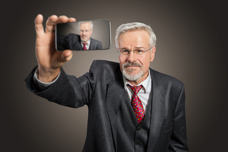 old man taking Selfieの写真素材