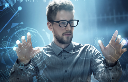 Man works on a HUD Touchscreen Interfaceの写真素材