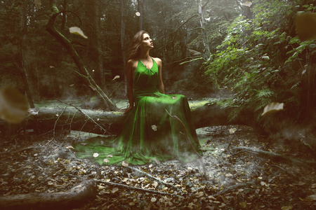 Woman wears a green dress in the forestの写真素材