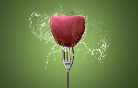 Apple on a fork (3D Rendering)の写真素材