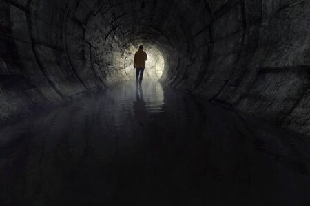 Man with a torch in a sewerの写真素材