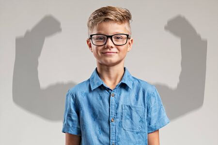 Child in front of big arms shadowの写真素材