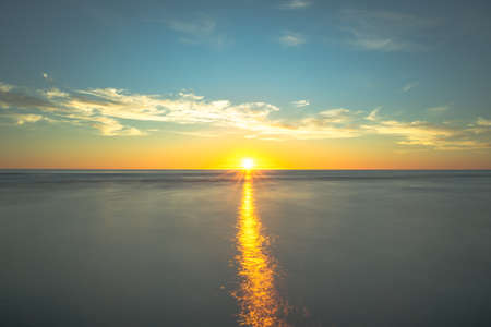 Golden sunset into the seaの写真素材