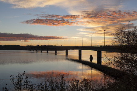 Bridge in the sunrise and vehicles going awayの写真素材