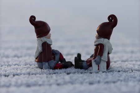 Two figures on a frosty pier waiting for the christmasの写真素材