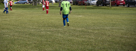 The backside of the goal keeper in a soccer gameの写真素材