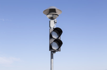 An isolated pole with a stop lightの写真素材