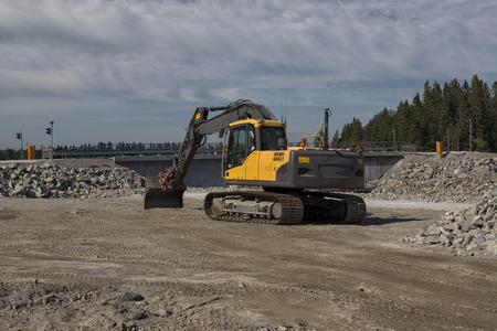 An excavator from behind in a construction siteの写真素材