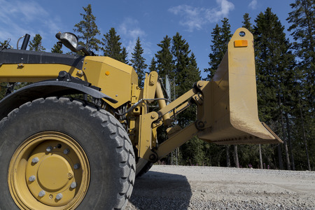 A closer look at at grader and its plow.