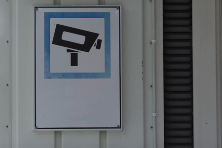 A camera survaillance sign on a wallの写真素材