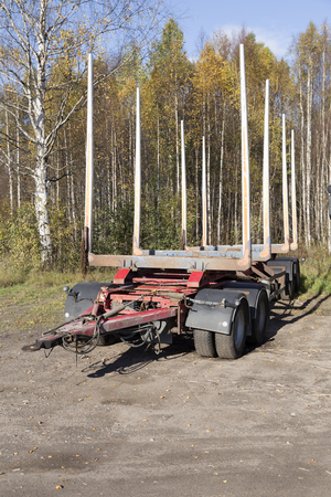 A timber trailer from the side in front of a birchの写真素材