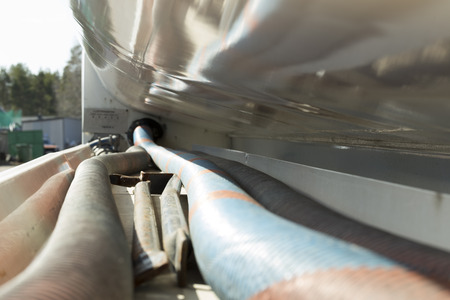 Some hoses on the side of a tank on a trailer