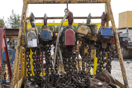 Electrical block and tackles with chains and hooks haning on a scaffolding